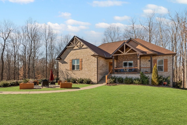 craftsman house featuring a patio, a hot tub, and a front yard