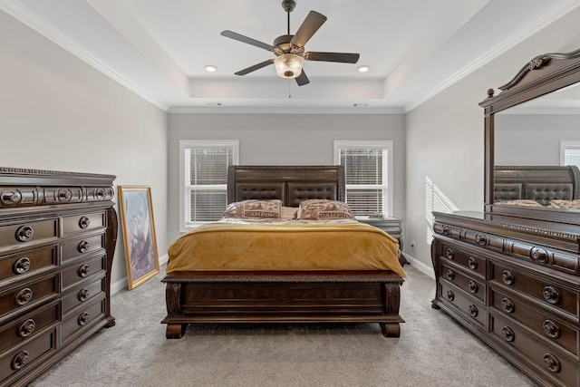 bedroom with light carpet, a raised ceiling, and ceiling fan