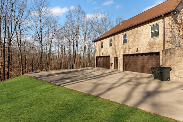 view of side of property with a garage and a lawn