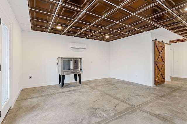 empty room featuring a wall mounted air conditioner, concrete floors, and a barn door