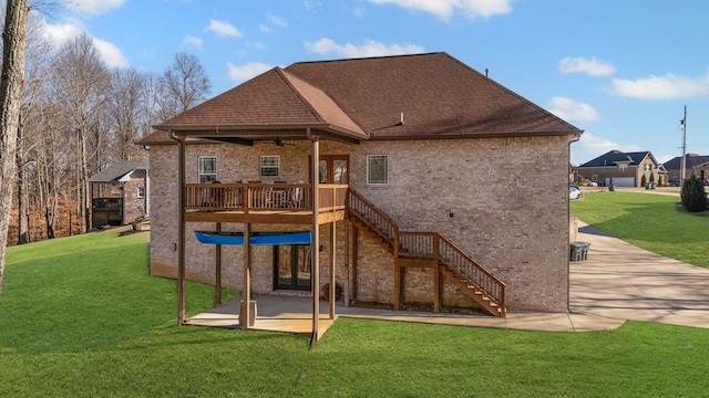 rear view of house with a wooden deck, a lawn, ceiling fan, and a patio area