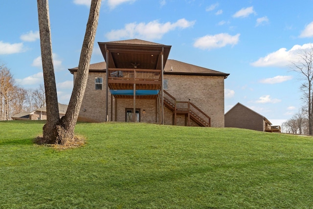 rear view of property featuring a wooden deck and a yard