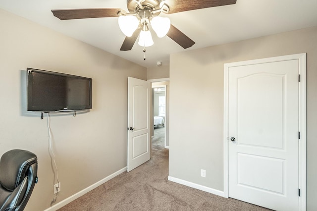 unfurnished bedroom featuring ceiling fan and light carpet