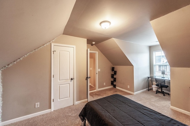 bedroom featuring lofted ceiling and carpet