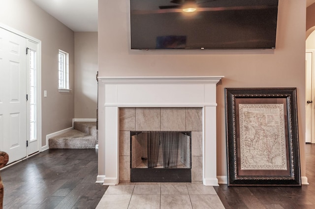 foyer with hardwood / wood-style flooring and a tile fireplace