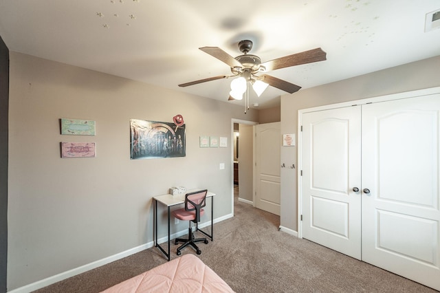 carpeted bedroom with ceiling fan and a closet