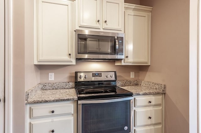 kitchen featuring light stone counters and stainless steel appliances