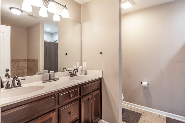 bathroom with vanity, tile patterned floors, and toilet