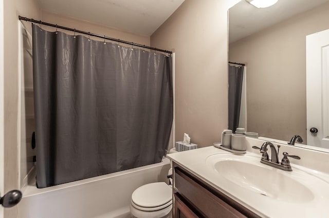 full bathroom featuring vanity, shower / bathtub combination with curtain, and toilet