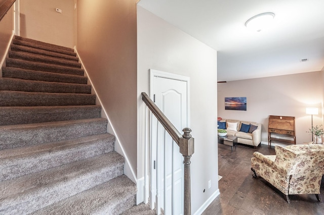 staircase with hardwood / wood-style floors