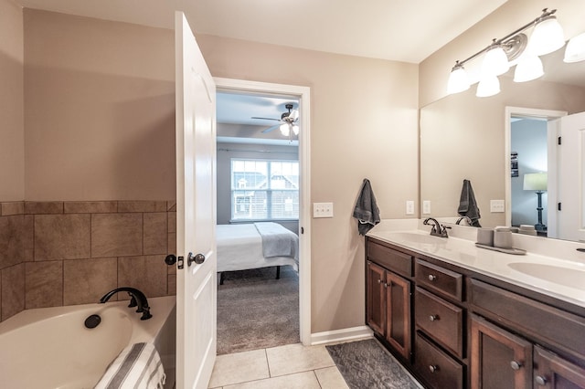 bathroom featuring vanity, a bathtub, tile patterned flooring, and ceiling fan