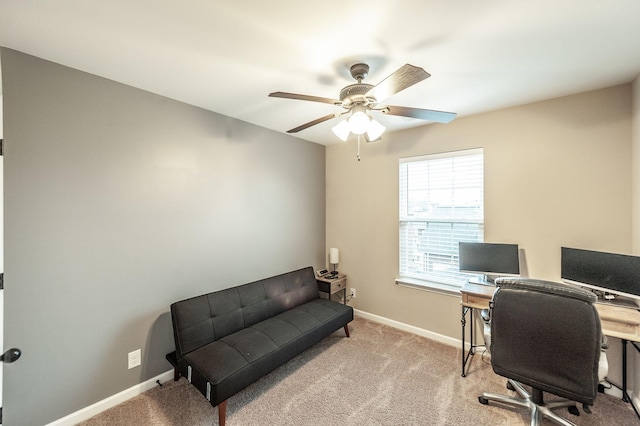 carpeted office space featuring ceiling fan