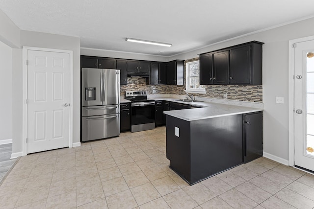 kitchen with light tile patterned flooring, appliances with stainless steel finishes, tasteful backsplash, sink, and kitchen peninsula