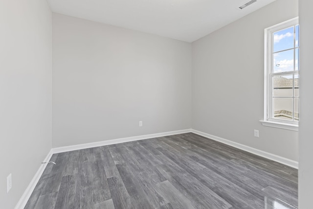 spare room featuring dark wood-type flooring