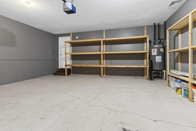 garage with a garage door opener and water heater