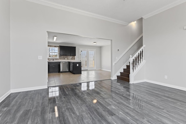 unfurnished living room with dark hardwood / wood-style flooring, ornamental molding, and french doors