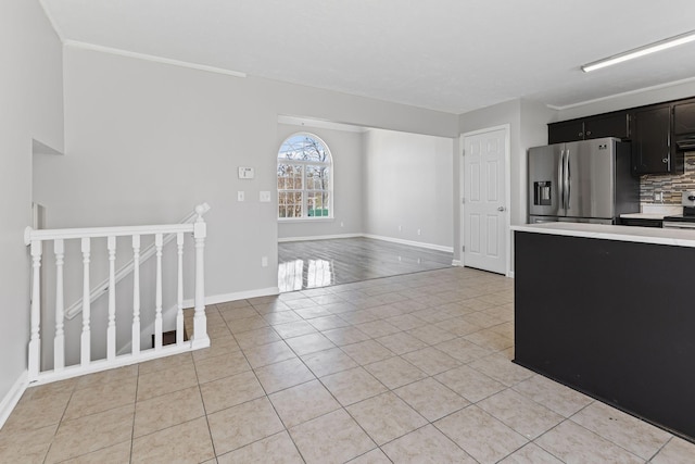 kitchen with backsplash, stainless steel appliances, and light tile patterned floors