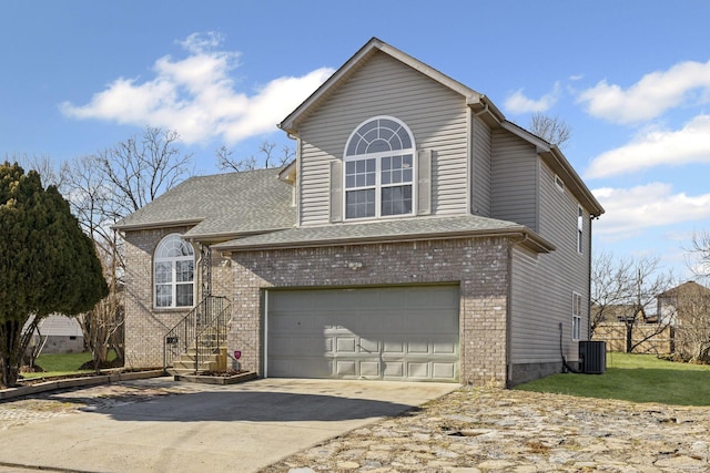 view of property featuring a garage and central air condition unit