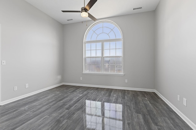 empty room with dark hardwood / wood-style floors and ceiling fan