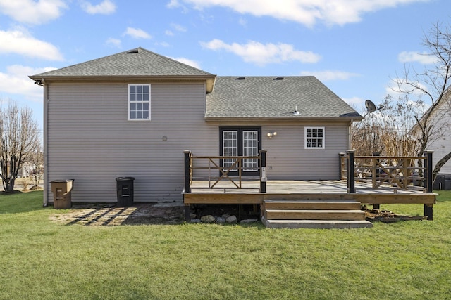 back of property with a lawn and a deck