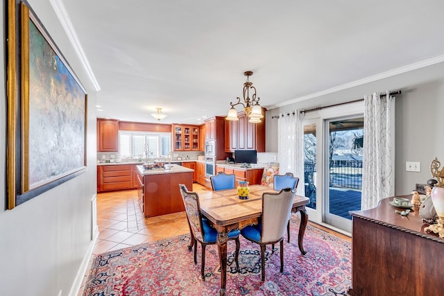 dining room with crown molding and light tile patterned floors