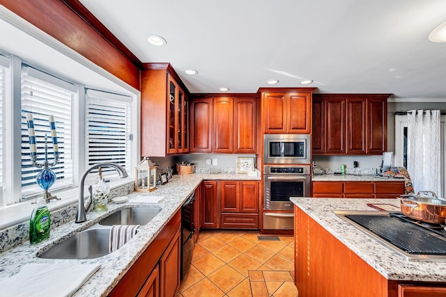 kitchen featuring sink, light tile patterned floors, light stone countertops, and appliances with stainless steel finishes