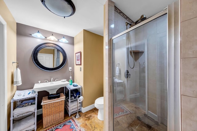 bathroom with an enclosed shower, vanity, and toilet