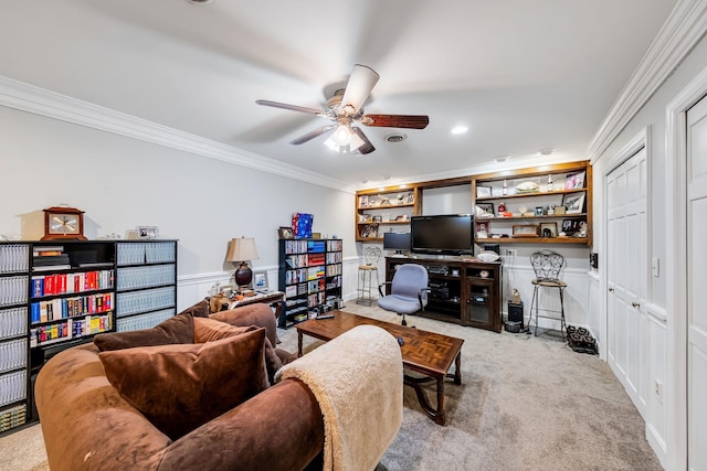 carpeted living room featuring ceiling fan and ornamental molding