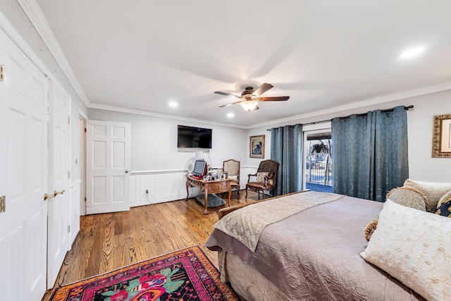 bedroom with hardwood / wood-style flooring, ceiling fan, and crown molding