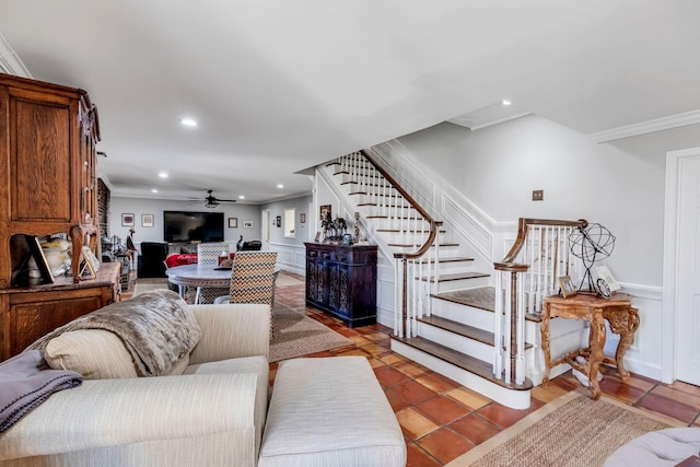 tiled living room with crown molding and ceiling fan