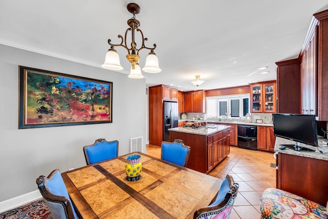 dining room featuring sink, light tile patterned floors, and a notable chandelier