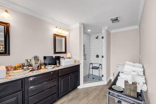 bathroom featuring ornamental molding, vanity, and a shower with shower door