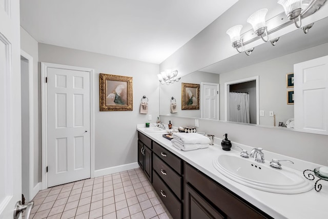 bathroom with vanity, tile patterned floors, and a chandelier