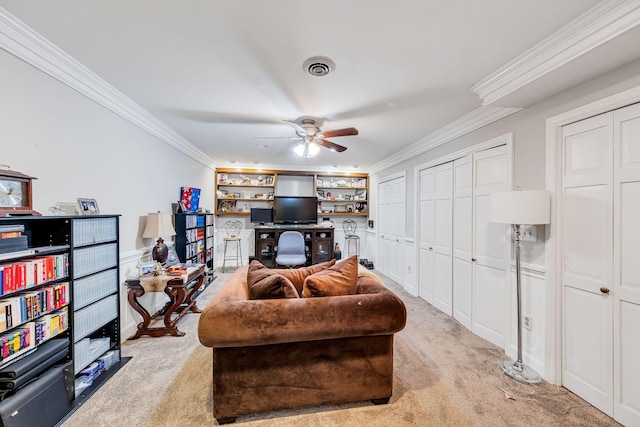 living room with ceiling fan, light colored carpet, and ornamental molding