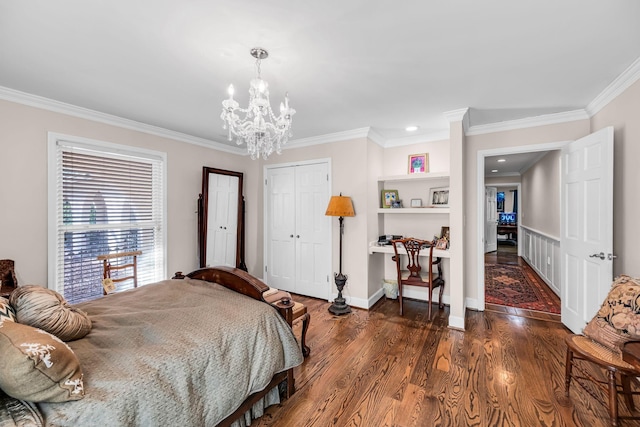 bedroom featuring dark wood-type flooring, crown molding, a closet, and a notable chandelier