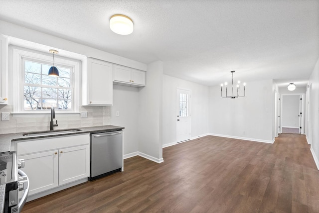 kitchen featuring pendant lighting, dishwasher, sink, and white cabinets