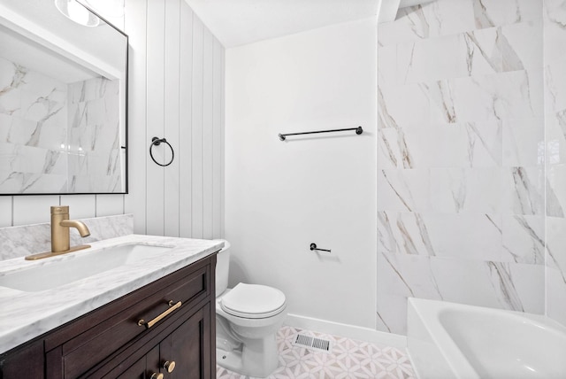 full bathroom featuring vanity, tiled shower / bath combo, and toilet