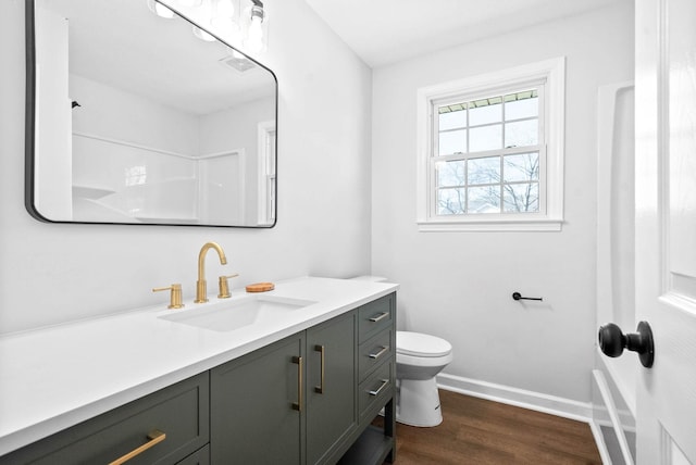 bathroom with vanity, toilet, and hardwood / wood-style floors