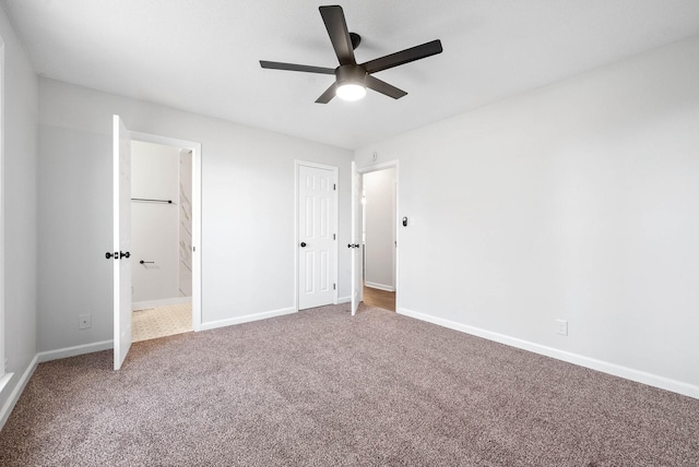 unfurnished bedroom with connected bathroom, carpet floors, and ceiling fan