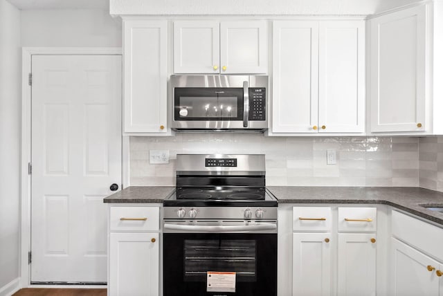 kitchen featuring backsplash, appliances with stainless steel finishes, and white cabinets