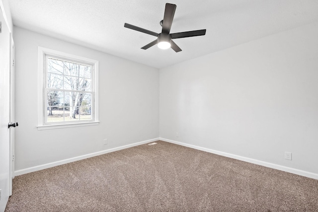 carpeted empty room with a textured ceiling and ceiling fan