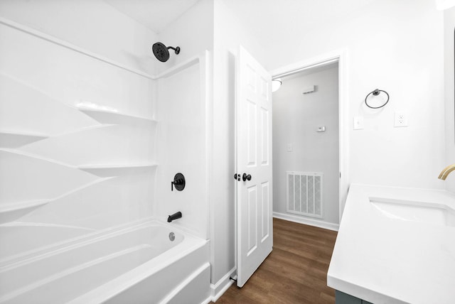 bathroom featuring vanity, shower / tub combination, and wood-type flooring