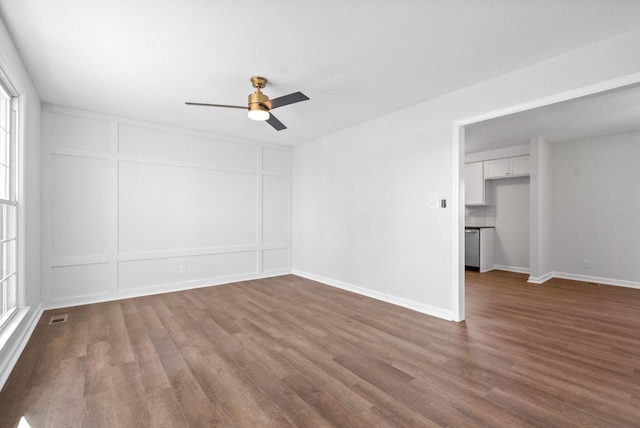 unfurnished room with dark hardwood / wood-style flooring and ceiling fan