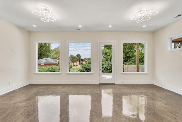 unfurnished room with concrete flooring