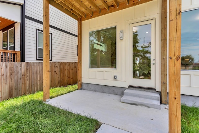 view of exterior entry featuring a patio