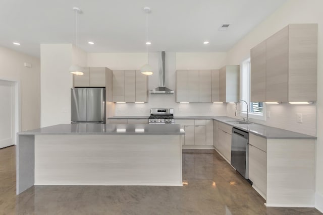 kitchen with wall chimney range hood, sink, hanging light fixtures, stainless steel appliances, and a kitchen island