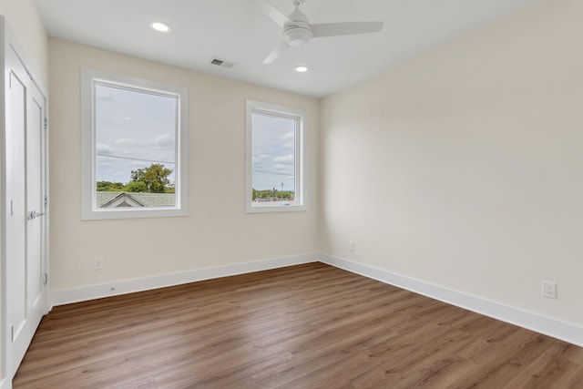 unfurnished room featuring ceiling fan, a healthy amount of sunlight, and light wood-type flooring