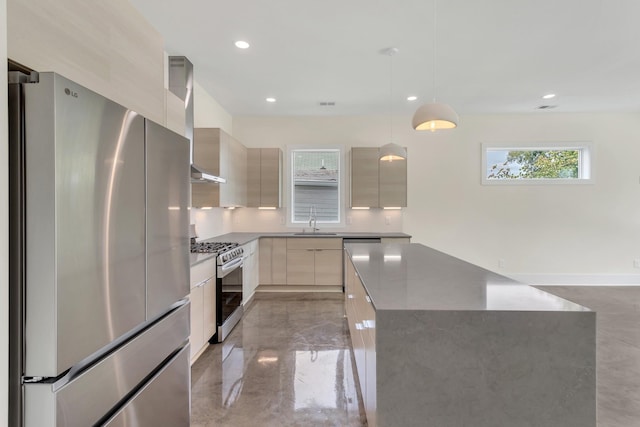 kitchen featuring wall chimney exhaust hood, sink, decorative light fixtures, a center island, and appliances with stainless steel finishes