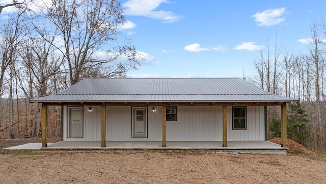 rear view of property featuring a porch