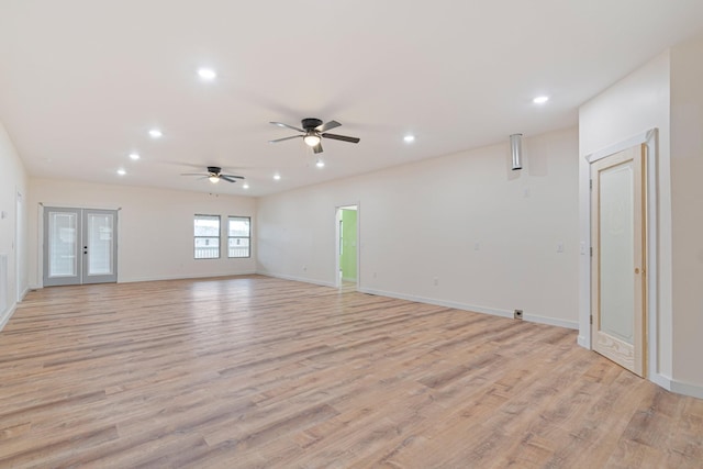 spare room featuring french doors, ceiling fan, and light hardwood / wood-style floors